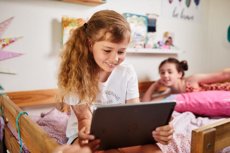Child holds ipad