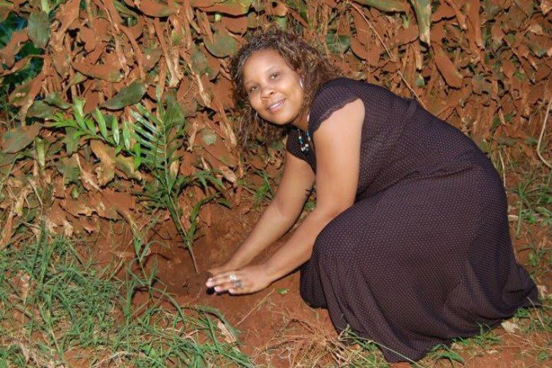 Angeline works with plants in the ground