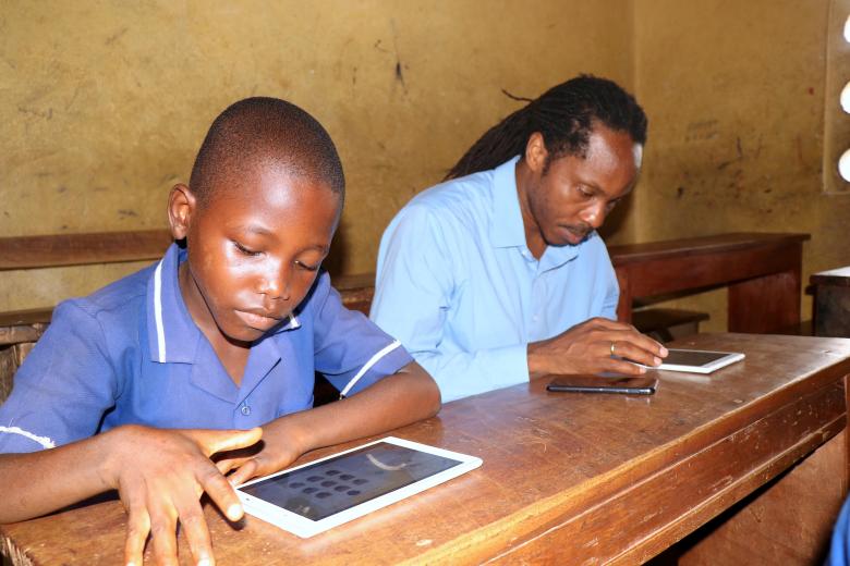 Minister of Education observing the learning using one of the Tab