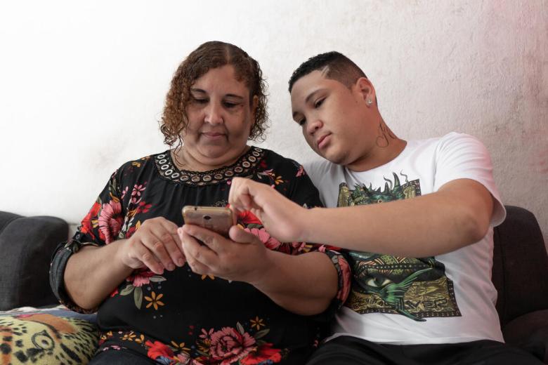 mother and son checking mobile phone