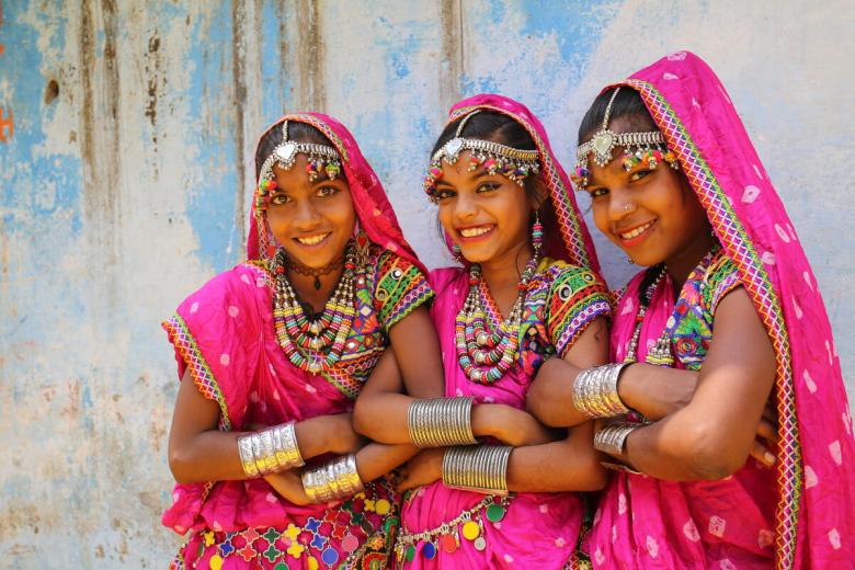 Varsha and her friends, Shivkanya and Gareema, dressed in traditional costumes in India.