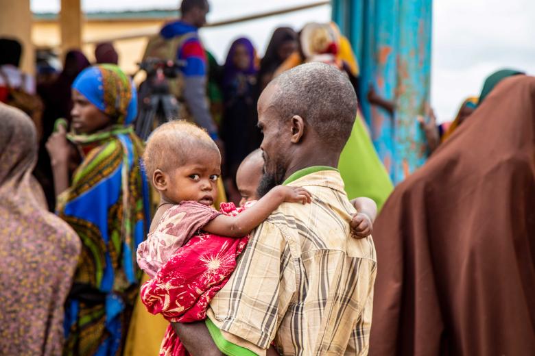 A father comes to a World Vision clinic in Baidoa, southern part of Somalia to receive support for his malnourished kids.