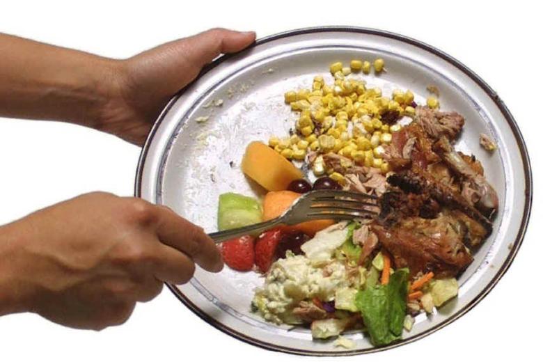 Scraping a plate of food