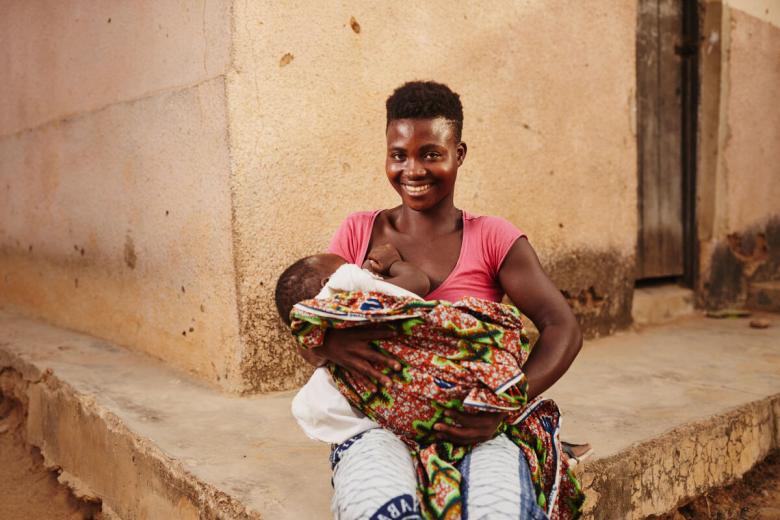 Elizabeth and her child attending a training session with World Vision Ghana