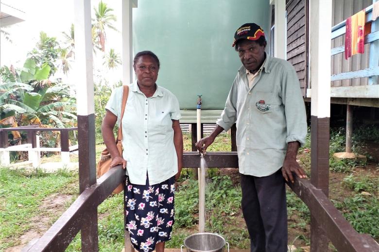 Sr. Maureen Damela (left) and a WASH Committee member testing the newly installed tank.