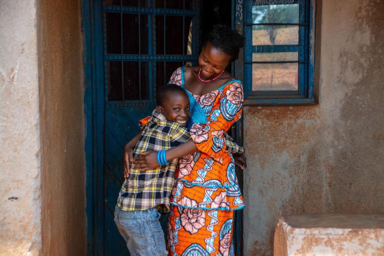 Empowered mother stands with her son