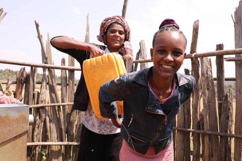 Girl in Ethiopia collects water from a water point near her home