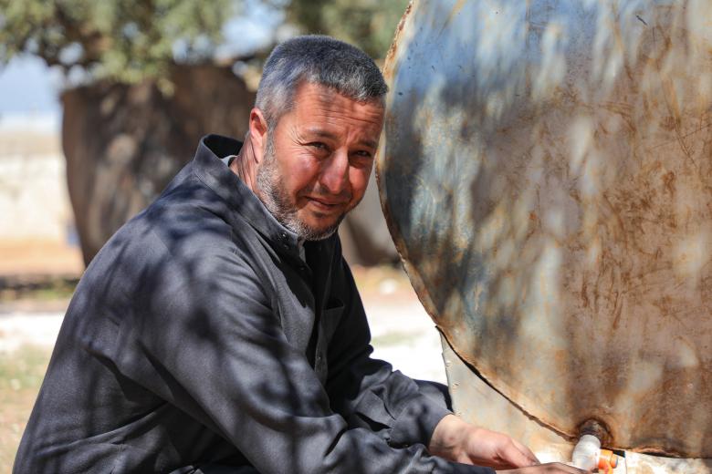 Samer* filling water from the water tank.