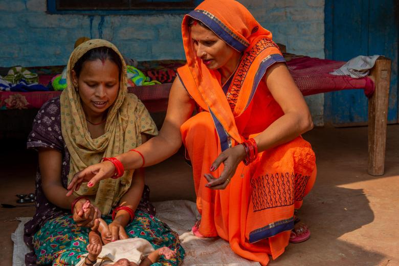 Community health worker helping mums in india