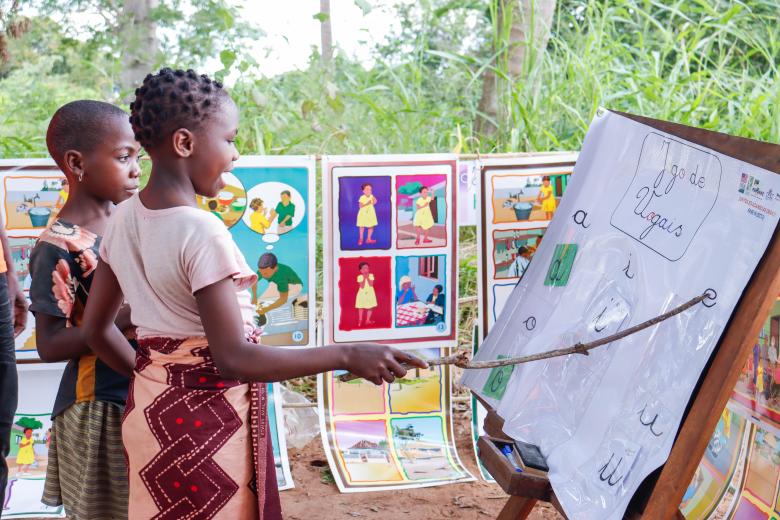 Children perform vowel exercise to improve literacy abilities in Reading Camp