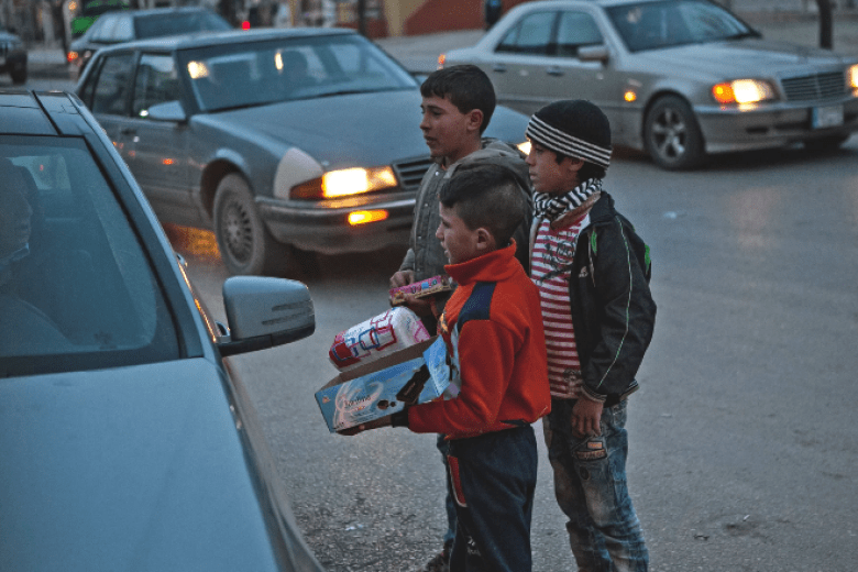 Children selling items to passing cars in Lebanon