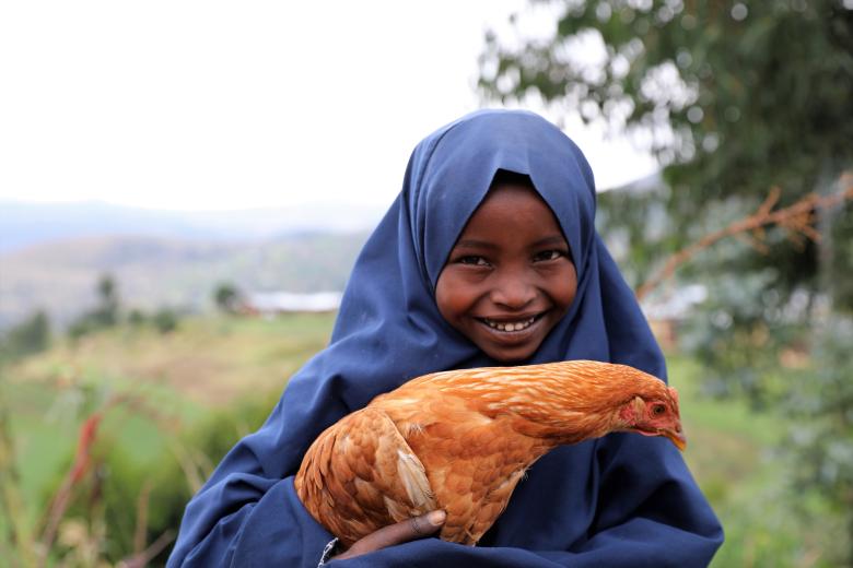 Sabontu holding chicken