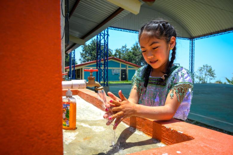 Girl in Guatemala washing her hands