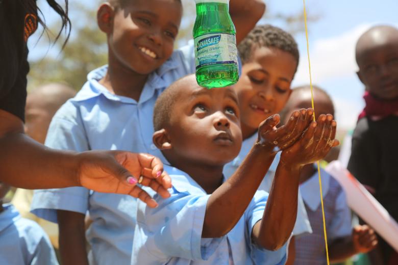 A child learns how to correctly wash hands with water and soap so as to prevent diseases during the 2018 Global Handwashing Day national celebrations held in Kitui County, Kenya. ©2018 World Vision/ Photo by Susan Otieno
