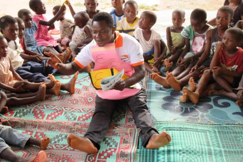 Elijah reads to children at a World Vision reading camp in Ghana