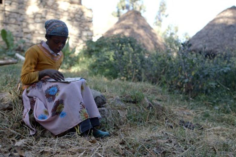 Sebile reads a book in Ethiopia