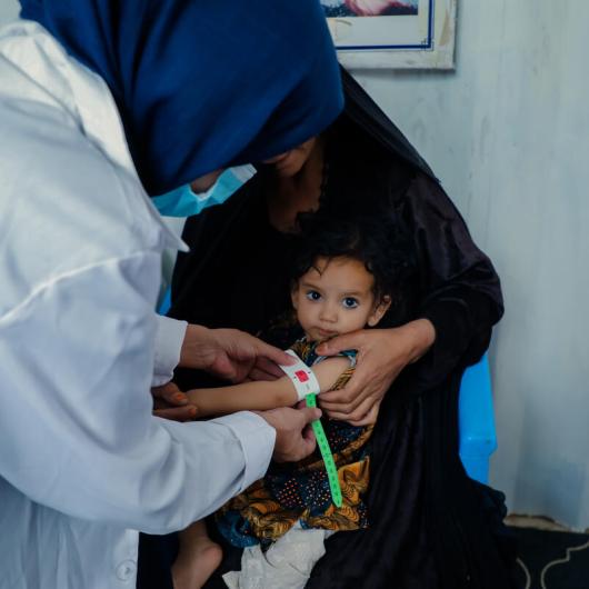 Child in Afghanistan is being checked for malnutrition