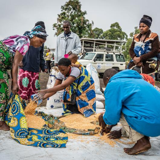 Internal displaced people sharing meal after a food distribution at Kanyaruchinya IDP camp