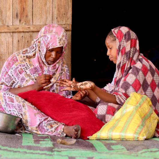 two young girls preparing themselves for Henna night