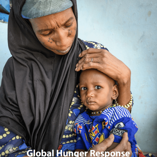 This is the cover page of the GHR Phase II strategic plan, featuring a mother cradling her child.