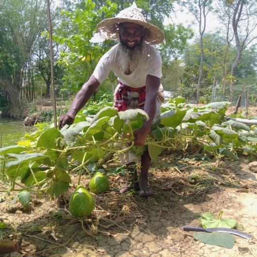 a man bending over some farm produce