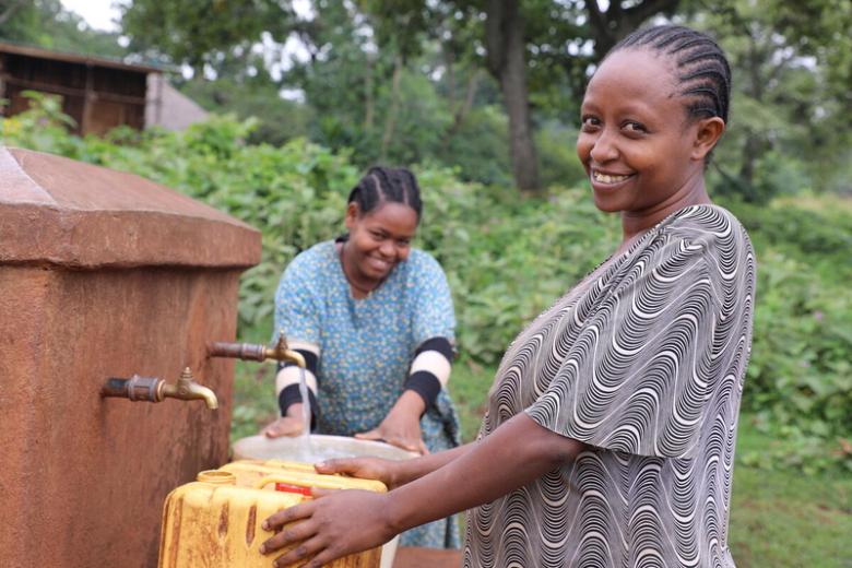 Woman getting water from tap