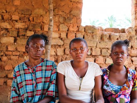 Maria sits with her daughters Joelle and Jeanette in a village in Dibaya territory. The girls walked for three months to get to Kasai Central from Tshikapa, where they grew up. Maria sits with her daughters Joelle and Jeanette in a village in Dibaya territory. The girls walked for three months to get to Kasai Central from Tshikapa, where they grew up.