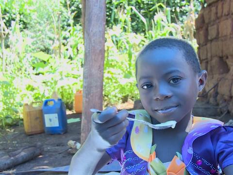 child eating biofortified beans made porridge.jpg