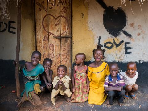 A group of children in front of a house