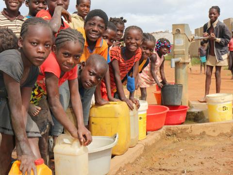 Children in Angola holding clean water