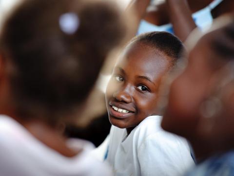 A Haitian girl smiles in school