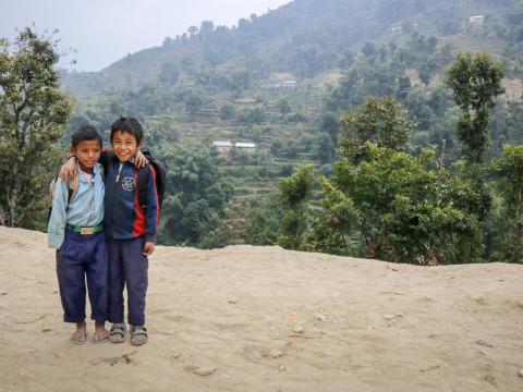 Two Nepal boys stand outside their school