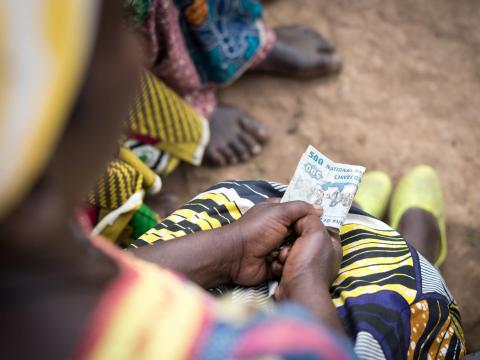 A woman holds cash