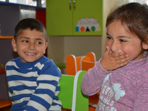 A Georgian girl smiles in a classroom