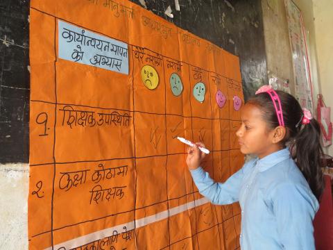 A Nepal girl writes in school