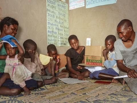 Mukonda with his family- he has four children whom he encourages to read through the reading corner and his has also taken up reading through this iniatitive.jpg