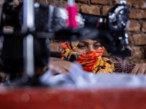 Woman with a veil using a sowing machine