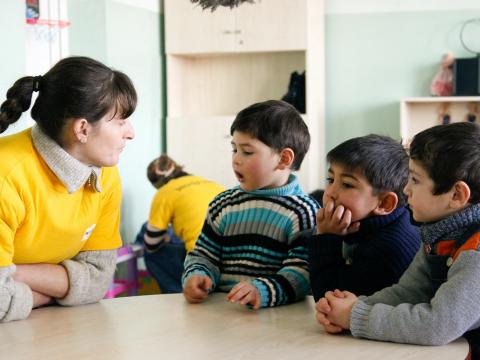 Georgia children at school with World Vision staff