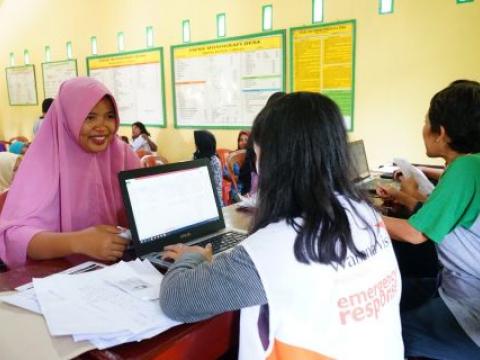 Asfiani holding her proof of identity, a requirement for participation in the social protection programme's multipurpose cash assistance project in Central Sulawesi