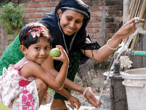 Mother with daughter using clean water