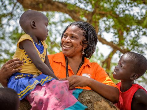 A World Vision employee with local children