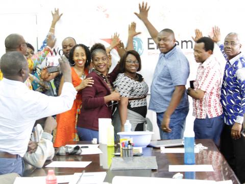 The staff are expressing their commitment and involvement in the achievement of the campaign's objectives by placing of the prints of their hands