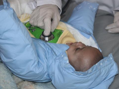 Baby being checked by a health worker in North West Syria