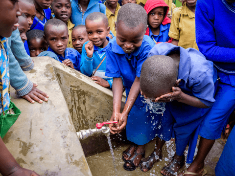 Children using clean water to wash hands and face