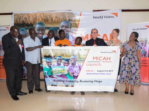 World Vision Uganda National Director, Jason Evans, Refugee Response Director, Jennifer Neelsen, and Arua District Resident District Commissioner (RDC), Nahori Oya (Guest of honour) , and some children beneficiaries officially launching the MICAH program in Arua.