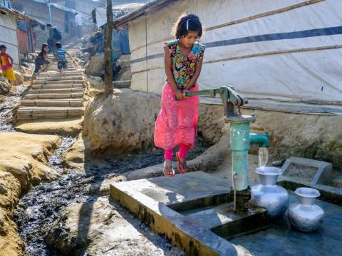 Sixty-one NGOs working with Rohingya refugees in Bangladesh and those internally displaced in Myanmar are calling for recognition of Rohingyas’ human rights, as well as more funding to help improve living conditions.  Here: A Rohingya girl pumps water from a tube-well, one of thousands installed by NGOs across the Kutupalong refugee camp.  Photo: Jon Warren/World Vision