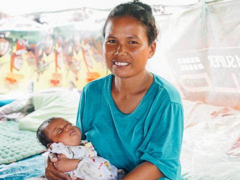 Indonesian mother holding two month old baby