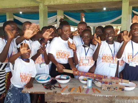 Some children showing off their work after bead making session 