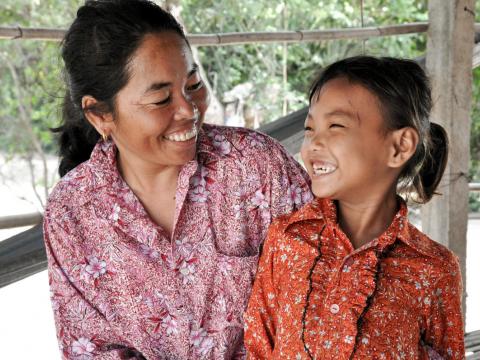 Khmer mother and daughter smile at each other