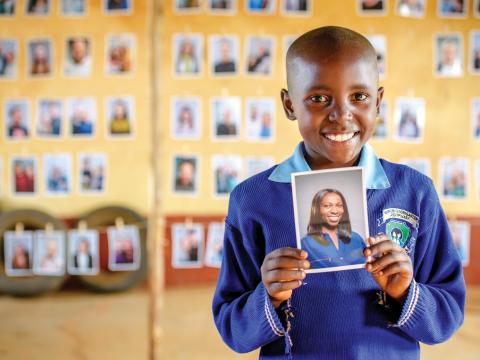 Nine-year-old Mary holds a picture of her sponsor that she chose.